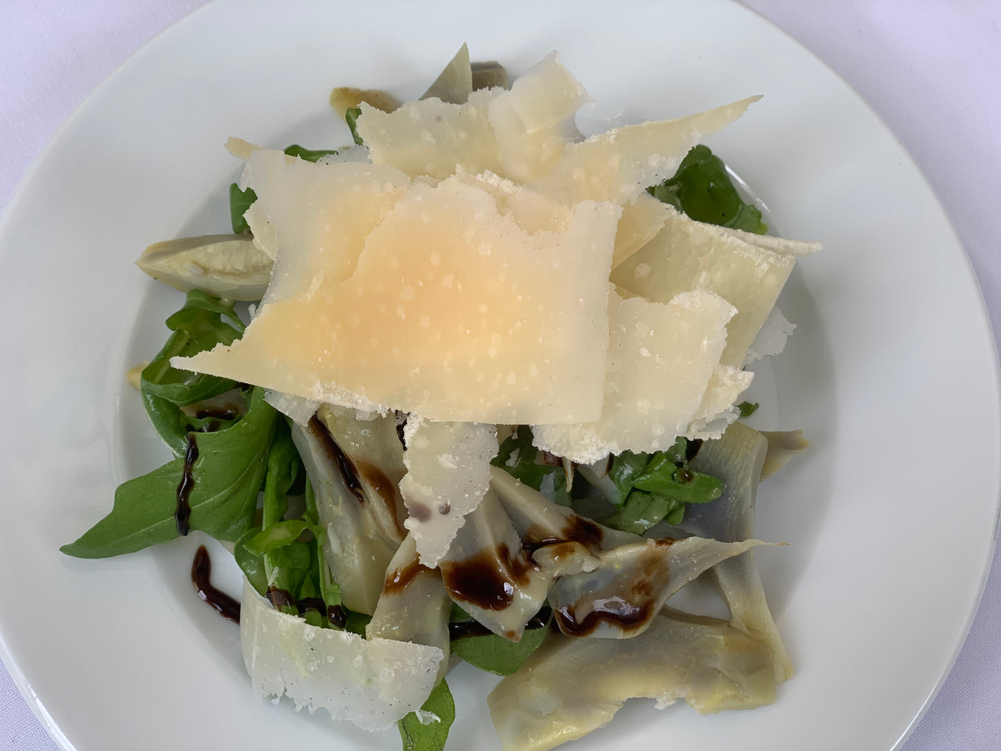 Combinación de la arúgula, corazón de alcachofa y láminas de parmesano grana padano aderezada con vinagreta de limón la cual da a esta ensalada un toque muy fresco, puede servirse como entrada o acompañando algún plato fuerte. La porción es para 6 personas.
